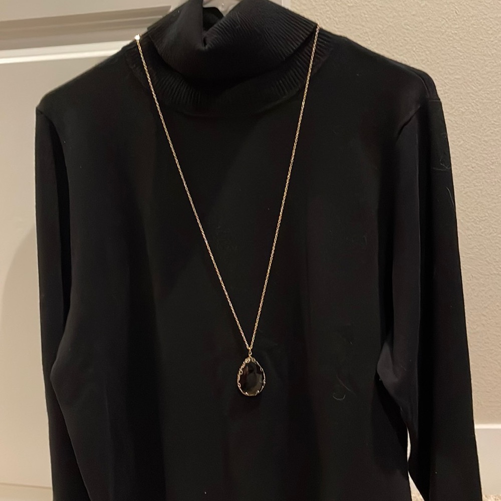 Gold chain with black stone.